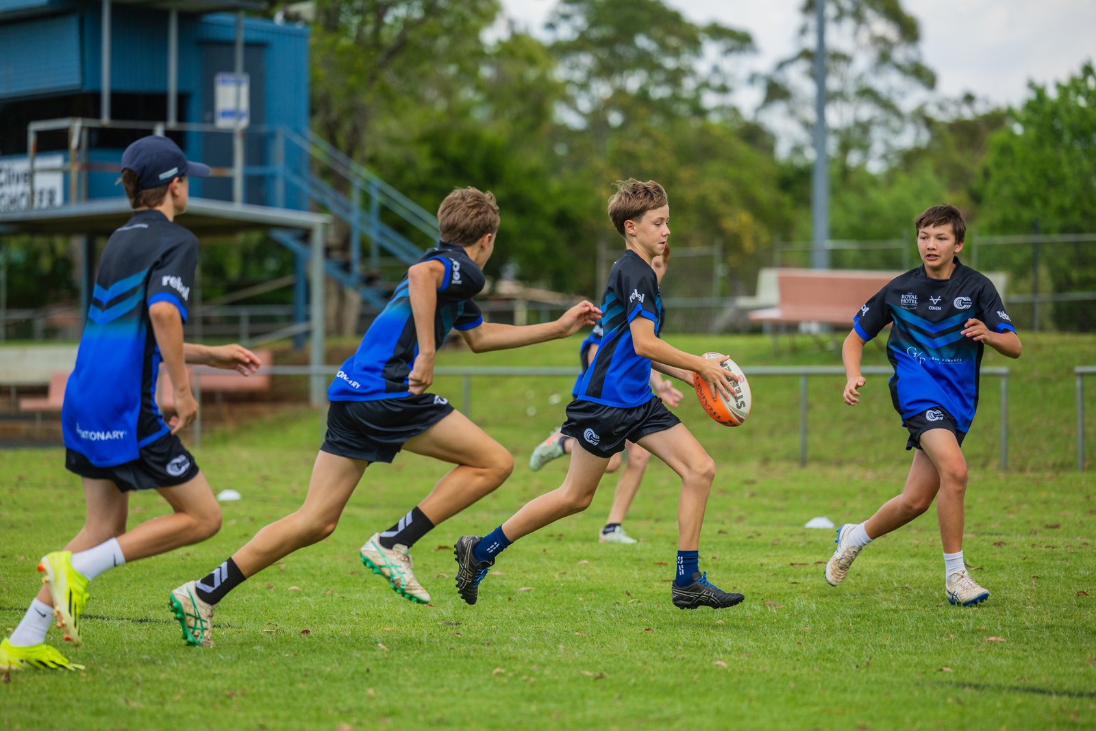 Boys running a rugby league drill at a Triple C Academy training session