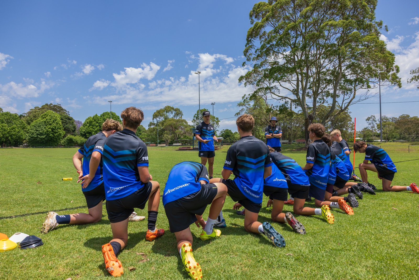 Boys team huddle during a briefing at a Triple C Academy training session