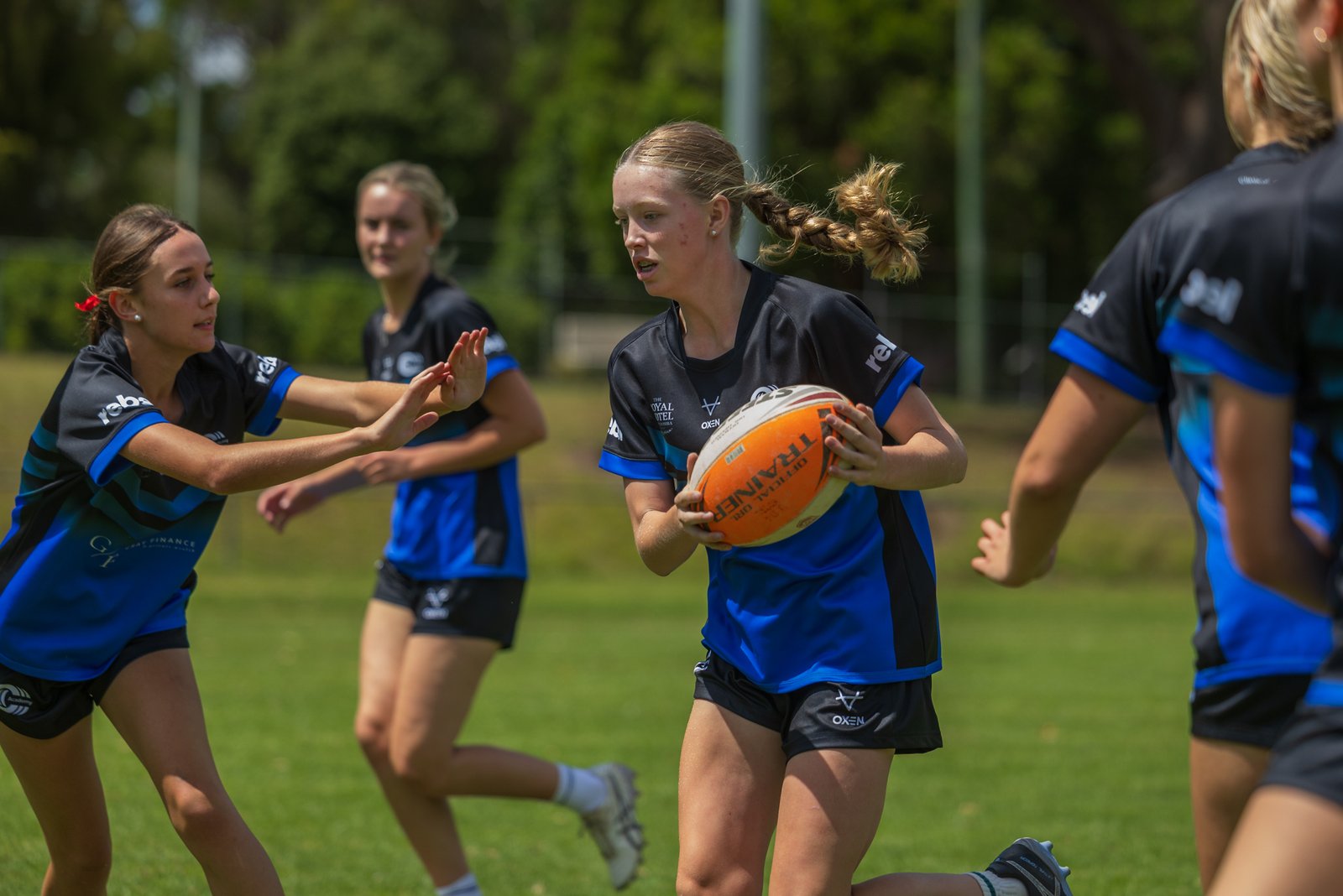 Girls playing a rugby league drill at a Triple C Academy training session